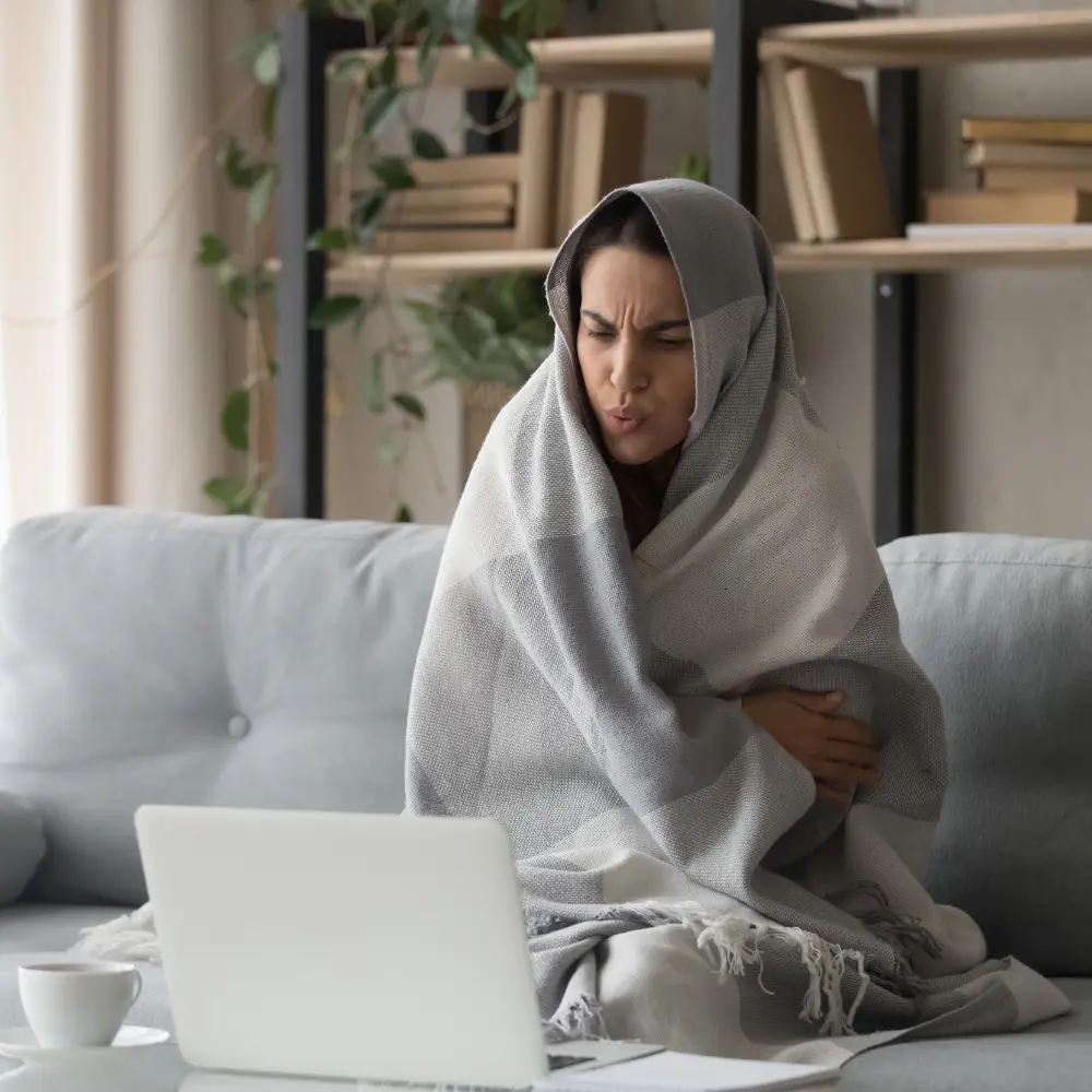 female on sofa cold in front of laptop