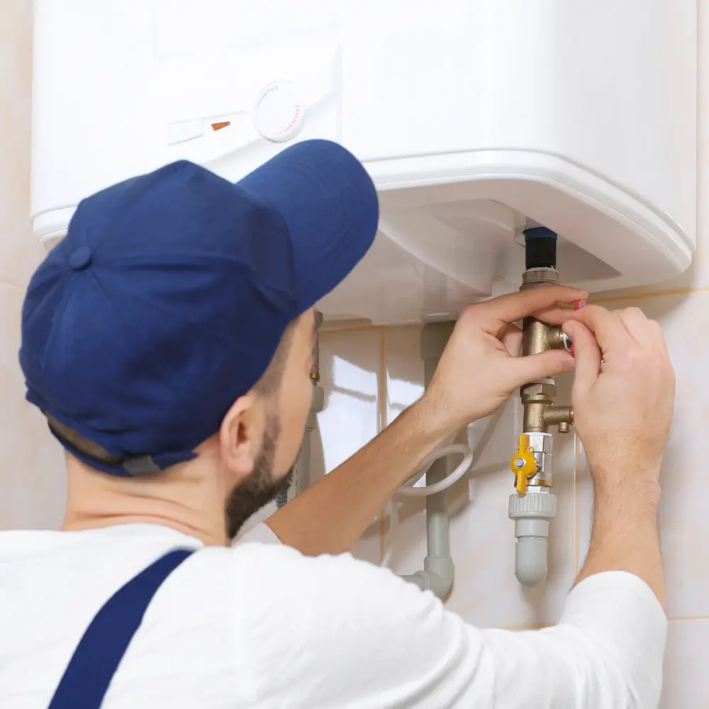 tech giving maintenance to water heater